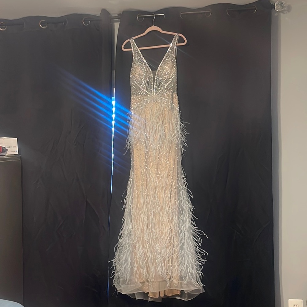 Its a cream dress with light bule feathers and silver rhinestones